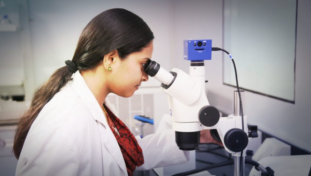 Research person with microscope